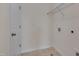 Functional laundry room with tile flooring and wire shelving for storage at 1904 Birdhouse Ln, Wake Forest, NC 27587