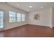 Open room with neutral walls, durable wood-look flooring, and direct access to outdoor patio at 1904 Birdhouse Ln, Wake Forest, NC 27587