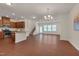 Spacious living area showcasing wood floors, modern lighting, and an open floor plan leading to the kitchen at 1904 Birdhouse Ln, Wake Forest, NC 27587