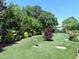 Beautifully landscaped backyard with mature trees and manicured lawn at 2000 Howson Rd, Raleigh, NC 27603