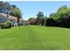 Spacious backyard with manicured lawn and mature trees, perfect for outdoor activities at 2000 Howson Rd, Raleigh, NC 27603