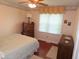 Bedroom with pink walls, hardwood floors, a dresser, and a comfortable bed at 2000 Howson Rd, Raleigh, NC 27603