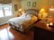 Inviting bedroom with hardwood floors, a comfortable bed, and plenty of natural light at 2000 Howson Rd, Raleigh, NC 27603