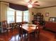 Dining room with wood flooring, ceiling fan, and a vintage china cabinet at 2000 Howson Rd, Raleigh, NC 27603