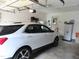 A white Chevrolet Equinox parked inside a clean and organized two-car garage with storage at 2000 Howson Rd, Raleigh, NC 27603