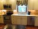 Modern kitchen featuring stainless steel appliances, cream cabinetry, and updated countertops at 2000 Howson Rd, Raleigh, NC 27603