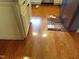 Hardwood flooring in the kitchen, complements the cabinetry and appliances at 2000 Howson Rd, Raleigh, NC 27603