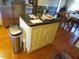 Kitchen island with a granite countertop and a stainless steel garbage can in view at 2000 Howson Rd, Raleigh, NC 27603