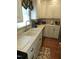 Bright kitchen featuring updated stainless steel appliances and cream-colored cabinetry at 2000 Howson Rd, Raleigh, NC 27603
