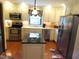 Bright eat-in kitchen with stainless steel appliances and a center island with granite countertops at 2000 Howson Rd, Raleigh, NC 27603