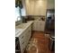 Bright kitchen featuring updated stainless steel appliances and cream-colored cabinetry at 2000 Howson Rd, Raleigh, NC 27603