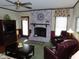 A living room featuring fireplace with decor, two leather chairs, and an entertainment center at 2000 Howson Rd, Raleigh, NC 27603