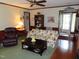 Living room offering cozy sofa and a view to the home's entry with hardwood floors at 2000 Howson Rd, Raleigh, NC 27603
