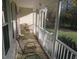 Relaxing screened porch with wicker furniture and a view of the yard at 2000 Howson Rd, Raleigh, NC 27603