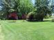 Expansive yard with lush lawn, mature trees, and professional landscaping at 2000 Howson Rd, Raleigh, NC 27603