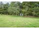 Large backyard with well maintained lawn and mature trees at 201 E Laramie Dr, Mebane, NC 27302