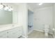 Modern bathroom with walk-in shower, vanity, and neutral tile flooring at 201 E Laramie Dr, Mebane, NC 27302