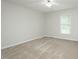 Bright bedroom with neutral carpet and paint, ceiling fan, and a window allowing natural light at 201 E Laramie Dr, Mebane, NC 27302