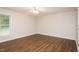 Bedroom with hardwood floors, a ceiling fan, and a window offering outdoor views and natural light at 201 E Laramie Dr, Mebane, NC 27302