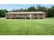 Charming single-story brick home with a large front yard and well-maintained landscaping at 201 E Laramie Dr, Mebane, NC 27302