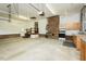 Spacious garage area with utility hookups, work benches, storage and garage doors at 201 E Laramie Dr, Mebane, NC 27302