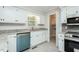 Updated kitchen with granite countertops, stainless appliances, and tile backsplash at 201 E Laramie Dr, Mebane, NC 27302