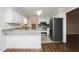 Spacious kitchen features granite countertops, stainless appliances, and breakfast bar at 201 E Laramie Dr, Mebane, NC 27302