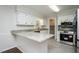 Well-lit kitchen featuring granite countertops, stainless appliances, and white cabinetry at 201 E Laramie Dr, Mebane, NC 27302