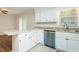 Bright kitchen boasts granite countertops, stainless steel appliances and white cabinets at 201 E Laramie Dr, Mebane, NC 27302