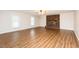 Spacious living room featuring new hardwood floors and a beautiful brick fireplace at 201 E Laramie Dr, Mebane, NC 27302
