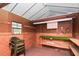 Utility shed featuring interior wall paneling, workbench, pegboard and access to electric at 201 E Laramie Dr, Mebane, NC 27302