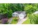 Aerial view showcasing the home, manicured landscaping, and driveway leading to the attached single-car garage at 203 Needle Park Dr, Cary, NC 27513
