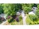 Aerial view of a well-maintained home with a landscaped yard and a driveway leading to the garage at 203 Needle Park Dr, Cary, NC 27513