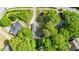 Aerial shot of a home showcasing its landscaped yard, driveway, surrounding greenery, and neighborhood at 203 Needle Park Dr, Cary, NC 27513