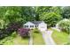 Aerial view of a lovely home with manicured lawn and driveway leading to an attached garage at 203 Needle Park Dr, Cary, NC 27513