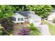 An aerial view of a charming home with a well-manicured lawn and a driveway leading to the garage at 203 Needle Park Dr, Cary, NC 27513