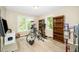 Spare bedroom with a bike, bookshelves, and large windows at 203 Needle Park Dr, Cary, NC 27513