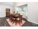 A formal dining room features a wooden table, comfortable seating, and a colorful rug at 203 Needle Park Dr, Cary, NC 27513