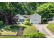 Beautiful home with detached garage, driveway, mature trees, and a staircase that leads to the house at 203 Needle Park Dr, Cary, NC 27513