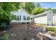 Exterior showing nice lawn, mature trees, brick trim, and a pathway to side entrance at 203 Needle Park Dr, Cary, NC 27513