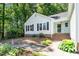 Charming single story home with a well-maintained yard, brick foundation, black shutters, and inviting entrance at 203 Needle Park Dr, Cary, NC 27513