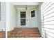 Front porch with brick steps leading to the front door with a screen at 203 Needle Park Dr, Cary, NC 27513