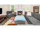 Comfortable living room with a fireplace, plush seating, and abundant natural light at 203 Needle Park Dr, Cary, NC 27513