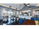 Bright clubhouse with expansive windows, sleek flooring, modern lighting, and a partial view of the kitchen at 204 Seagraves Creek Ln, Holly Springs, NC 27540