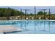 Community pool with handicap rail entry and lounge chairs at 204 Seagraves Creek Ln, Holly Springs, NC 27540