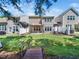 View of the back of the home showcasing the backyard and covered patio at 205 Hammond Wood Pl, Morrisville, NC 27560