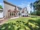 Spacious backyard featuring a covered patio and lush green lawn at 205 Hammond Wood Pl, Morrisville, NC 27560