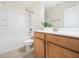 Clean bathroom features a vanity with wood cabinets, a mirror, toilet and a shower over tub at 205 Hammond Wood Pl, Morrisville, NC 27560