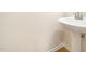 Clean bathroom with a modern pedestal sink and neutral wall color at 205 Hammond Wood Pl, Morrisville, NC 27560