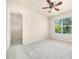 Neutral bedroom with ceiling fan, carpeted floors, window and closet at 205 Hammond Wood Pl, Morrisville, NC 27560